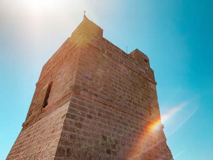 The newly restored Ta' Xutu tower in Wied iż-Żurrieq bathed in summer sunshine.